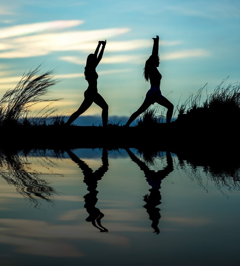 Woman meditating at sunrise